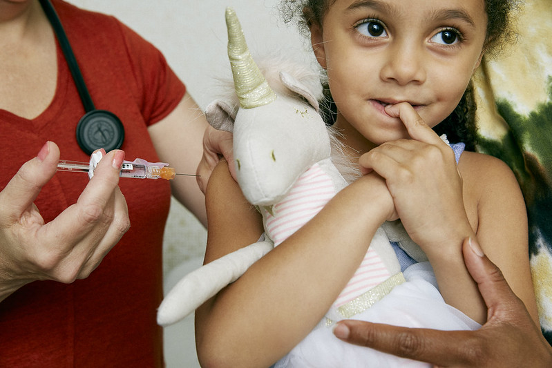 girl about to receive vaccine